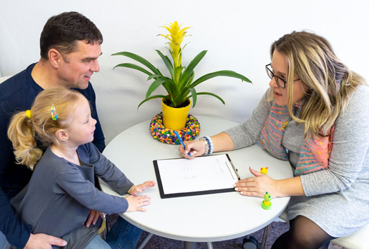 father and daughter talking with social worker