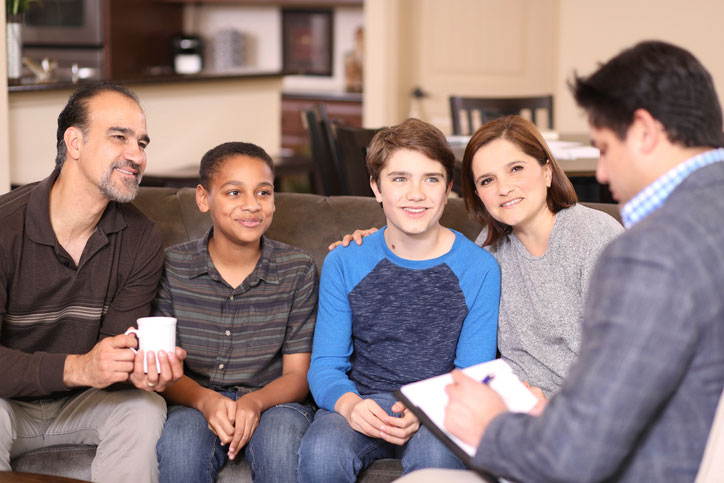 family with children talking with social worker