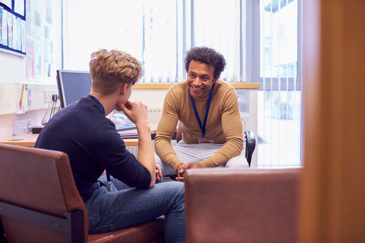 young man talking with social worker