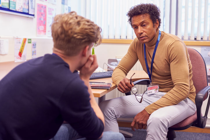 school social worker talking with young man