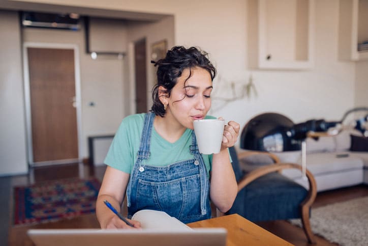 enjoying coffee while on computer at home