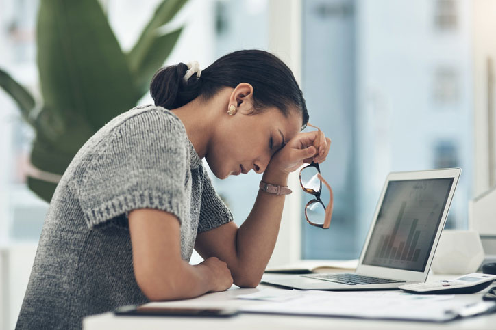 stressed young woman at her desk