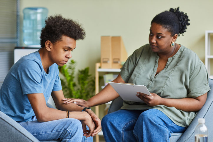 social worker consoling student at school