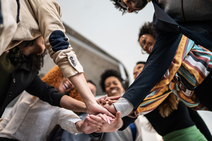 Group of women with their hands in a huddle