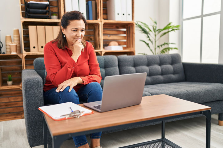 woman learning on laptop in living room