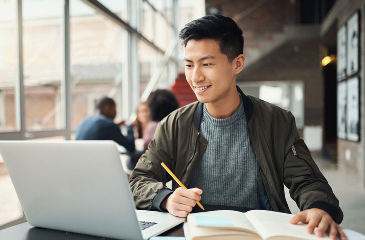 male student studying in the library