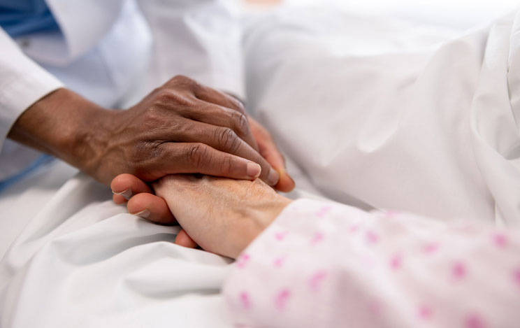 holding hands of hospice patient