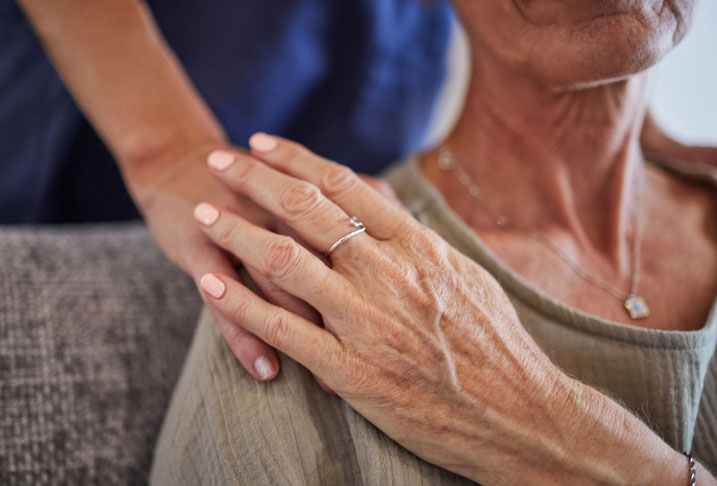 caring hand on her shoulder