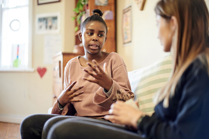 teen girl talking with social worker