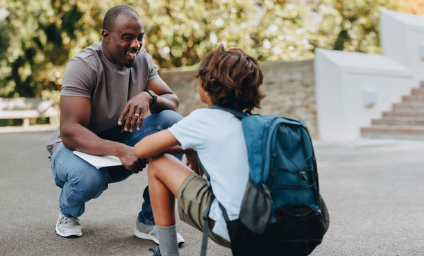 middle school boy talking with school social worker outside