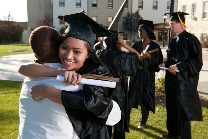 graduate hugging family