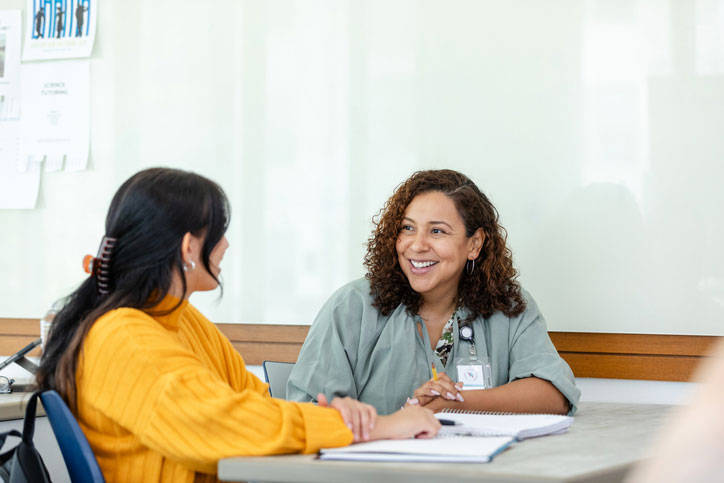 young student talking with school social worker