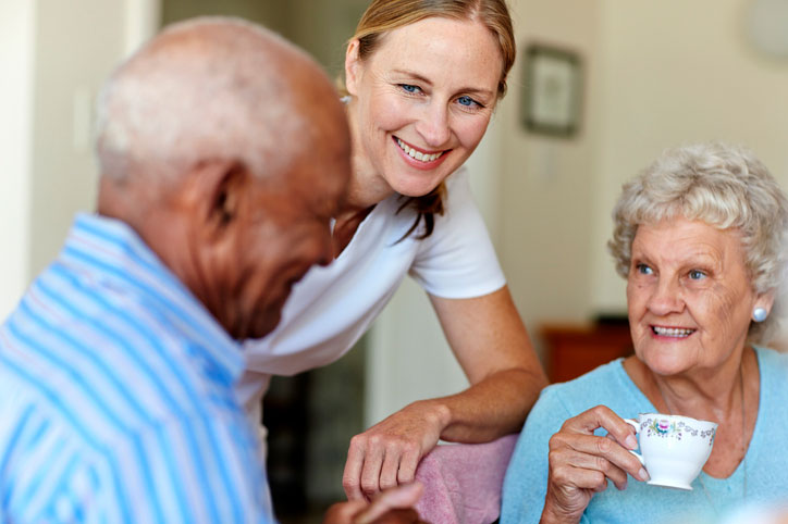 social worker talking with elderly couple