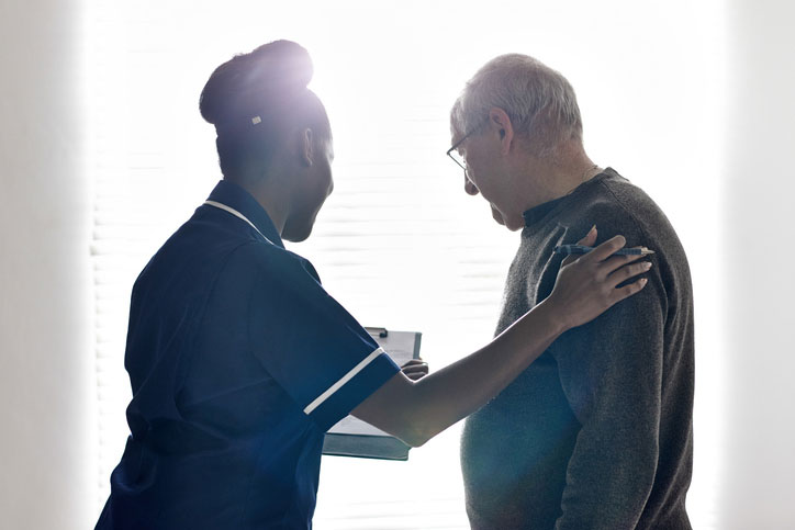 healthcare social worker talking with elderly patient