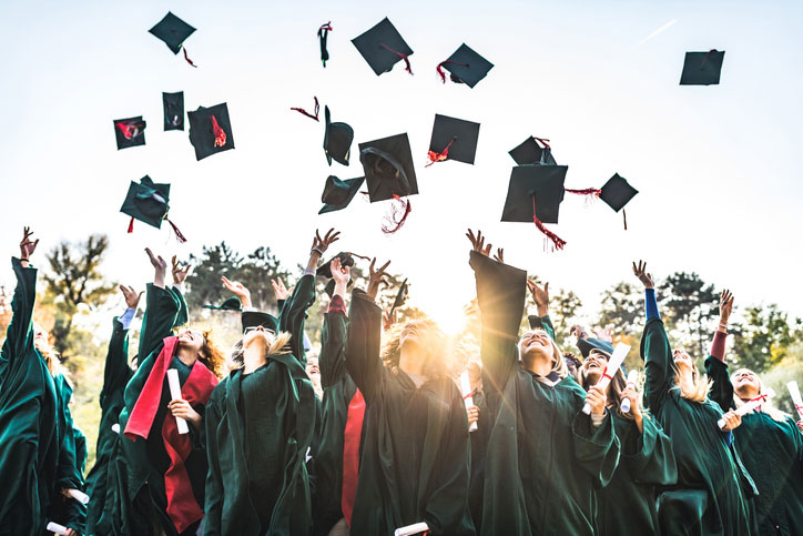 recent grads throwing caps in the air