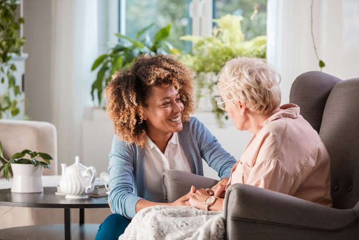 social worker talking with elderly woman