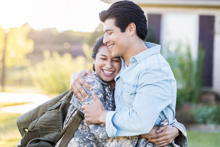 female soldier hugging husband